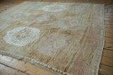 Vintage distressed Kars rug corner with chevron zigzag border and abrashed pale coffee, blush field.