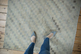 Distressed vintage Sparta rug showing worn checkered geometric pattern in ivory and slate tones.
