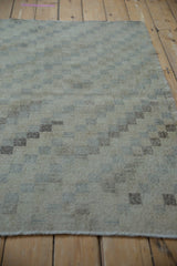 Distressed ivory and brown geometric checkered pattern showing wear to foundation.