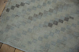 Detail of the distressed Sparta rug pile, showing worn checkered motif and soft neutral tones.