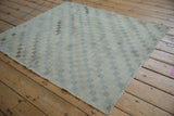 Aged pile and lattice checkered pattern of a distressed vintage Sparta rug.