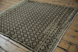 Distressed vintage Oushak rug with abrashes and paneled starburst geometric motifs.