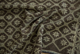 Distressed vintage Oushak rug showcasing chocolate brown and silver starburst geometric pattern and worn texture.