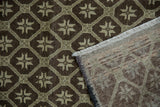 Distressed Oushak rug with charcoal geometric pattern, abrashes, fringe, and hand-knotted reverse.