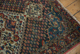 Worn pile of a vintage Baktiari rug, detailing the indigo field and ivory medallion.