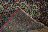 The hand-knotted back and machine-bound red edge of a vintage Persian Baktiari rug corner.