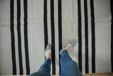 Hand woven Pakistani Kilim rug displaying bold charcoal and silver horizontal stripes.