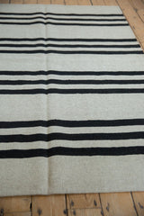 Hand woven Pakistani Kilim rug flatweave texture with silver and charcoal horizontal stripes.