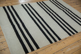 Geometric Pakistani Kilim rug with silver and charcoal flat weave horizontal stripes.