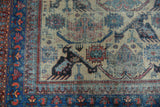 Vintage Afshar rug corner: geometric birds on an antique ivory field with sapphire blue and red borders.