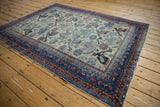 Vintage Afshar rug with finned birds, geometric plants on ivory, showing wear.