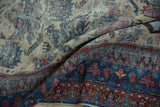 Worn vintage Afshar rug showcasing its sapphire blue border and red, orange geometric motifs.