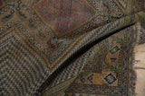 Fringed end of the antique Afshar rug, revealing geometric patterns and time-softened tones.