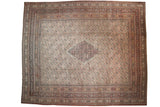 Antique Doroksh carpet with a stepped diamond medallion over an ivory field with an allover Herati design.