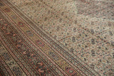 Time-softened Herati pattern and intricate border with visible knot heads on an antique Doroksh Persian carpet.