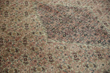 Close view of the time-softened pile along the stepped medallion of an antique Doroksh carpet.