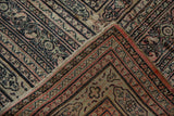 The secured side cord selvage and intricate border detail of a hand-knotted antique Doroksh carpet.