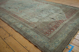 Worn side selvage, dusty teal border, and faded field of antique Bijar carpet.
