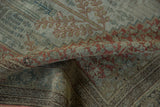 Distressed antique Bijar carpet texture revealing faded Herati motifs in powder blue, terracotta.