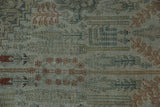 Detail of antique Bijar carpet's worn pile texture showing Herati motifs in dusty teal and terracotta.