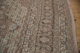 Even wear across to knot heads on a distressed Tabriz carpet, showing floral borders in rust and brown.