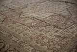 Soft, even wear across the hand-knotted pile of a distressed vintage Tabriz carpet.