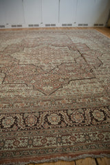 Low-angle view across the vintage Tabriz rug's intricate medallions and detailed border.