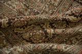 Close-up of the distressed Tabriz carpet's low pile, revealing even wear across the knot heads.