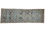 Distressed vintage Northwest Persian runner rug with blue, beige, and brown geometric starbursts.