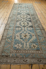 Distressed Northwest Persian runner featuring geometric starbursts and serrated leaf border.