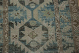 Distressed Northwest Persian runner detail, primitive serrated starbursts in dusty blues, beige, and brown.