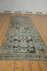 Distressed Northwest Persian runner with serrated leaf border and faded geometric pattern.
