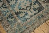 Distressed Northwest Persian rug end with worn fringe, serrated leaf border, and time-softened blue tones.