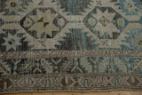 Distressed Northwest Persian rug: primitive motifs, serrated border in muted teal and beige.