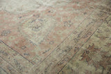 Distressed vintage Sparta carpet, worn knot heads, muted floral pattern in blush and beige.