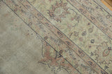Softened beige and blush floral patterns on a distressed vintage Turkish Sparta rug.