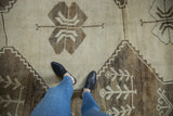 Primitive beige and brown geometric motifs on distressed Kars carpet pile, underfoot.