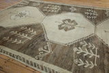 Close-up of vintage distressed Kars carpet shows beige germinating plant motifs, abrashes, and even wear.