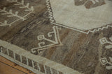 Distressed Kars carpet with brown abrashes and antique ivory geometric zigzags.