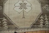 Distressed Kars carpet showcasing stepped geometric medallion, brown fishbone motif, and red fringe.