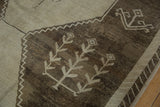 Distressed Kars carpet showing stepped zig-zag contour, primitive plant motifs, and abrashes.