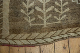 Distressed Kars carpet's beige, coffee brown fishbone border, with red warps.