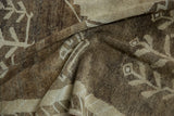 Distressed Kars carpet showing primitive floral pattern, warm brown abrash, and even wear.