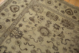 Curvilinear floral cross-sections and lotus motifs on the beige and chocolate vintage Egyptian Agra rug.