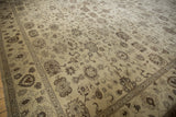 Beige and brown floral motifs of a vintage Egyptian Agra carpet's dense weave and detailed border.