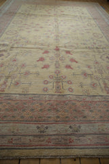Romanian Khotan carpet's dusty gold field with pale red pomegranate plants and mauve abrash.