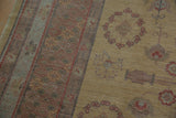 Textural detail of Khotan design carpet with dusty gold field and abrash in mauved border.