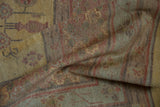 Folded Khotan design carpet showcasing abrash, dusty gold, and pale red pomegranate motifs.