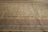 Dusty gold Romanian Khotan rug field with pomegranate motifs and detailed border.