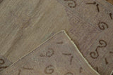 Distressed Khotan runner showing worn pile, visible foundation, and intact selvage.